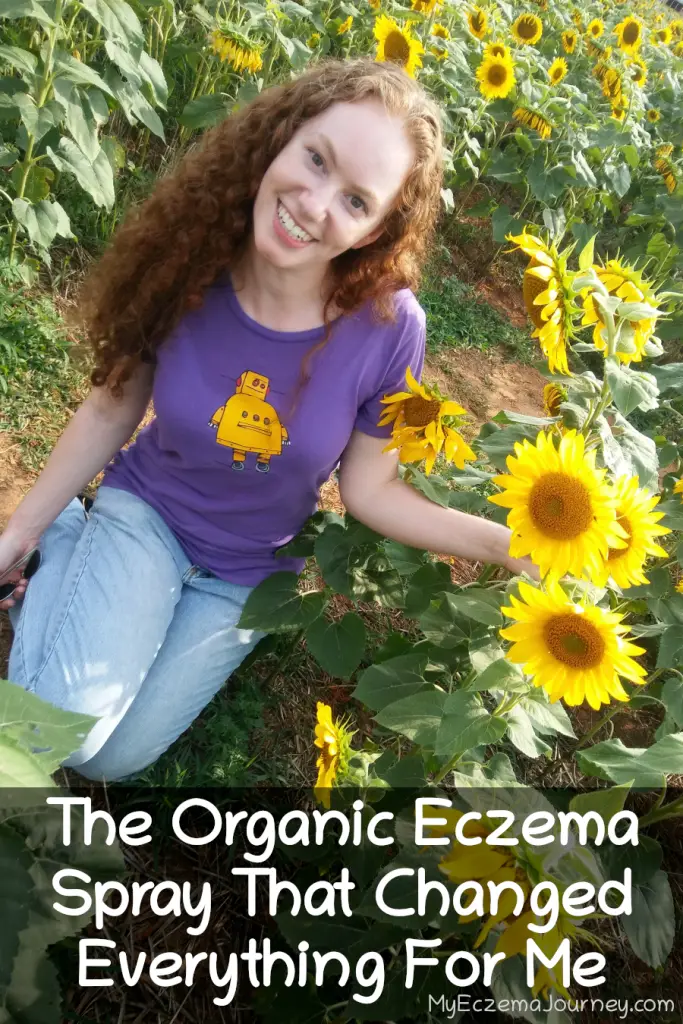 redhaired lady in sunflower field with text overlay: the organic eczema spray that changed everything for me